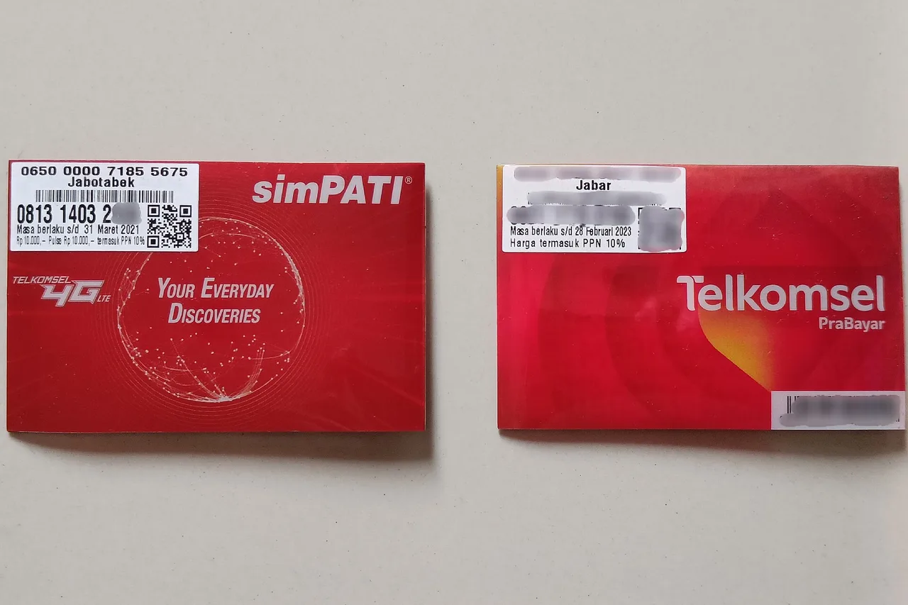 Deux pochettes de cartes SIM prépayées indonésiennes simPATI et Telkomsel Prabayar posées à plat