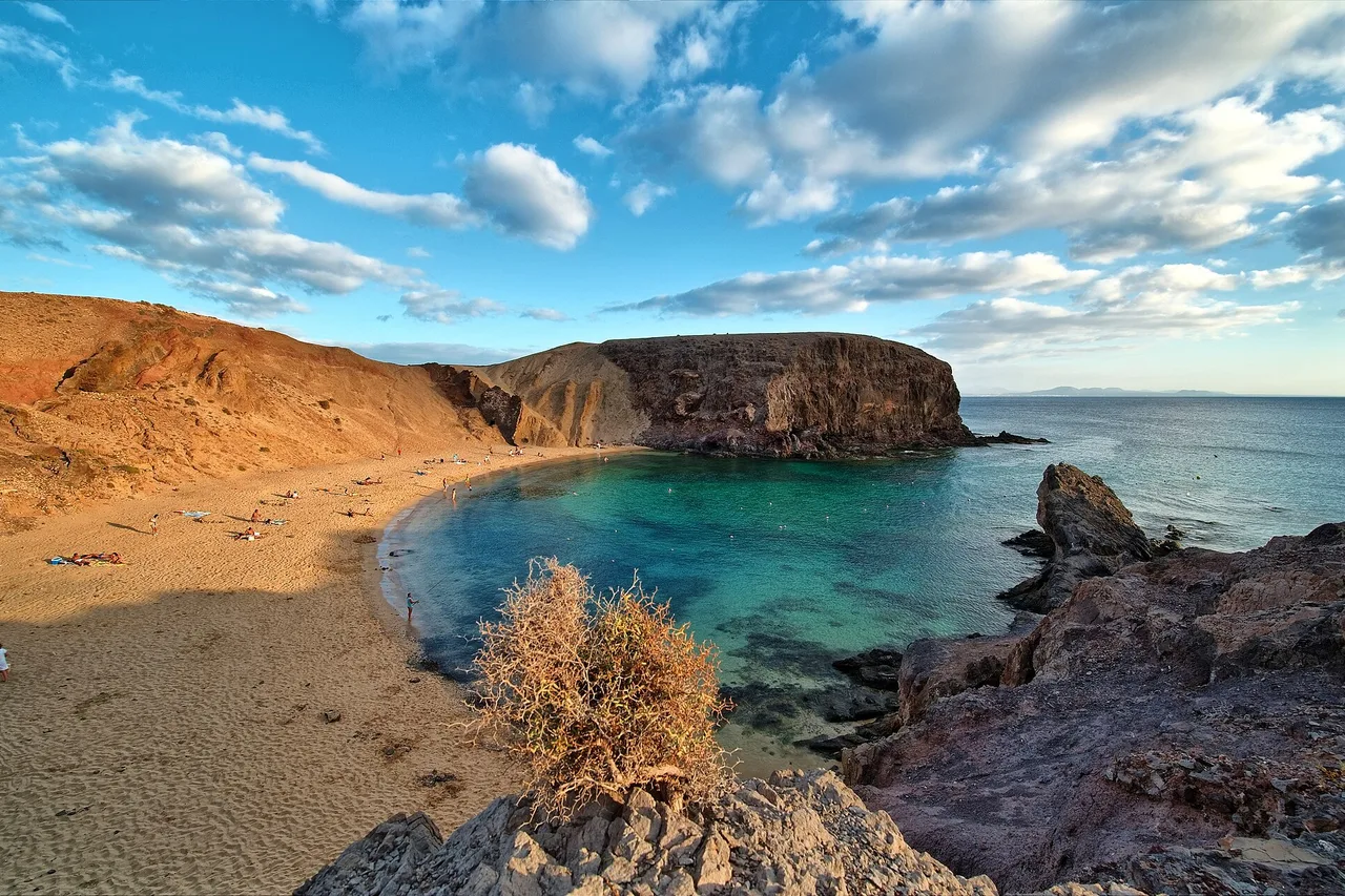 The turquoise cove of Playa de Papagayo framed by ochre cliffs, southern Lanzarote