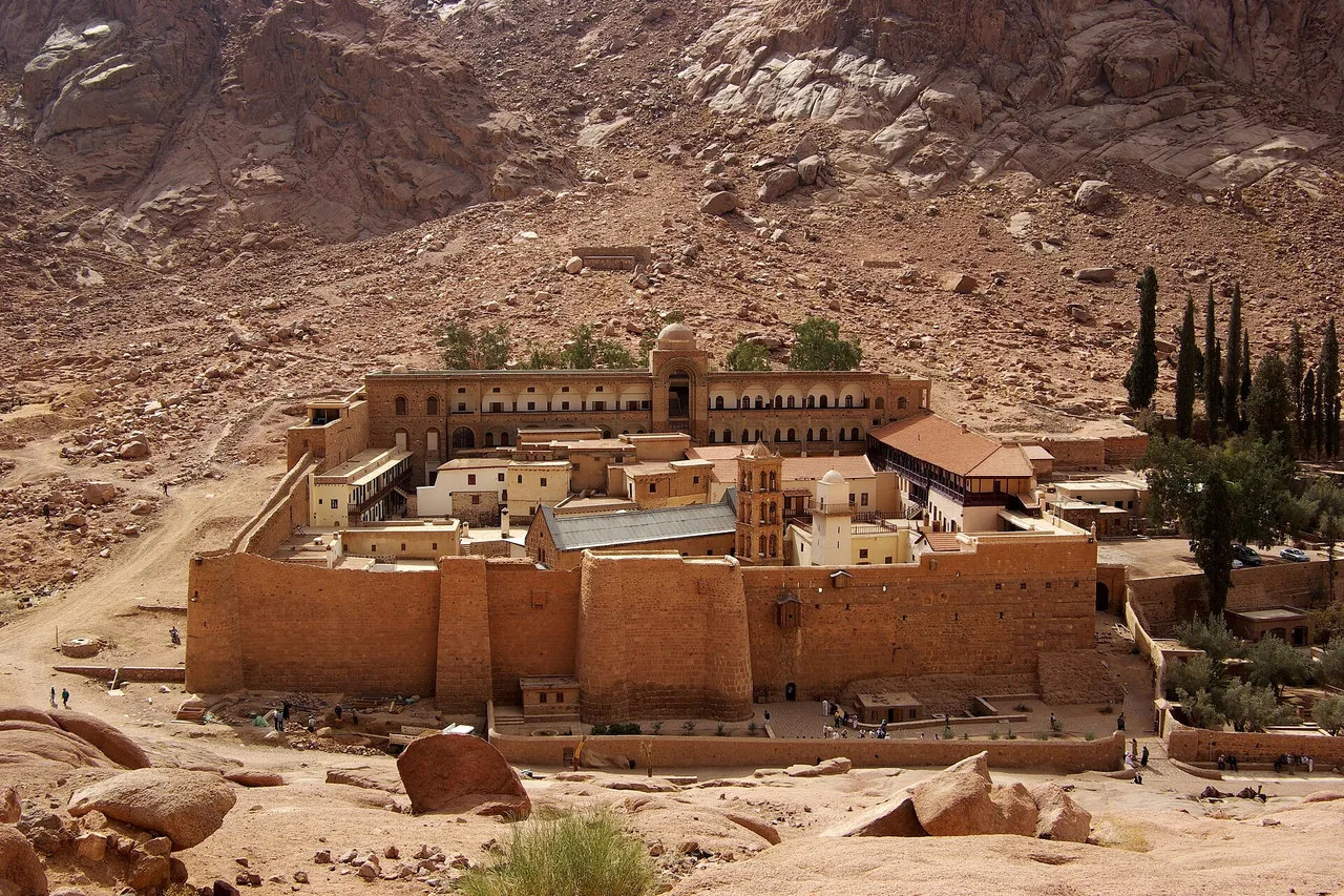 Saint Catherine's Monastery in South Sinai, surrounded by bare, reddish mountains.
