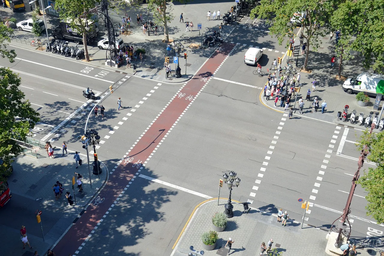 The crossroads of Passeig de Gràcia and Carrer de Provença in Barcelona, seen from above on a summer day