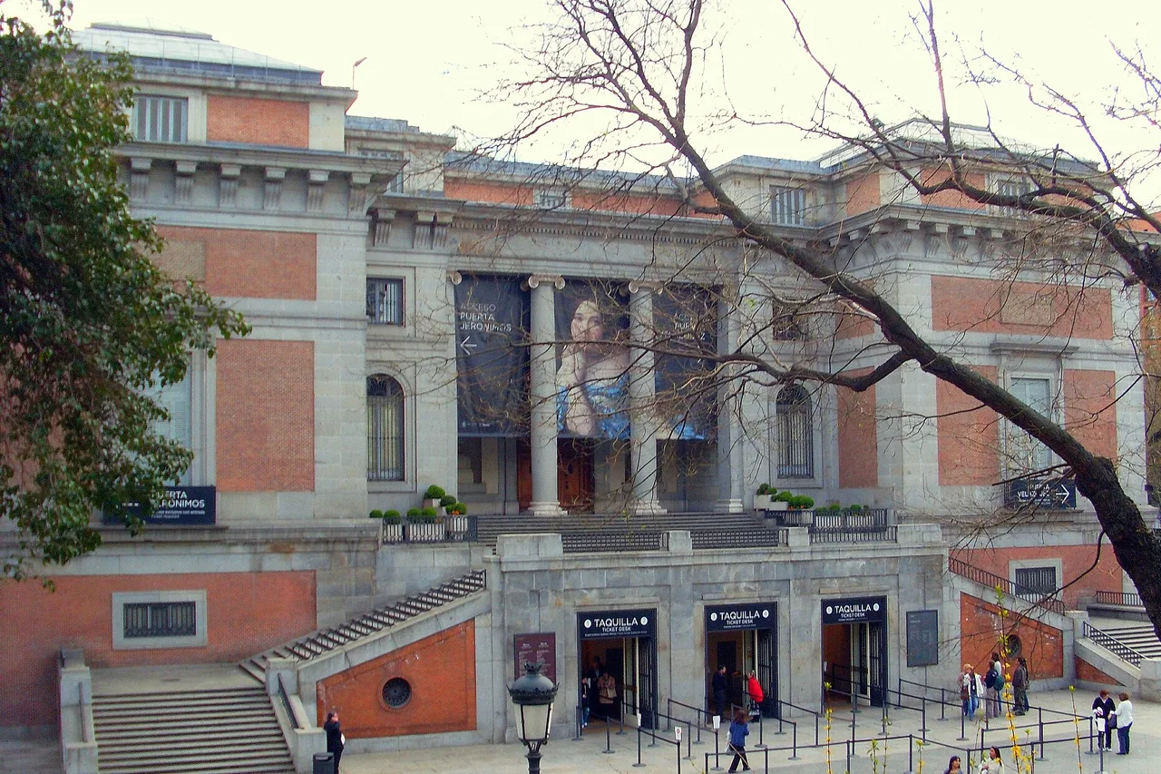 The neoclassical façade of the Prado Museum in Madrid, with visitors outside