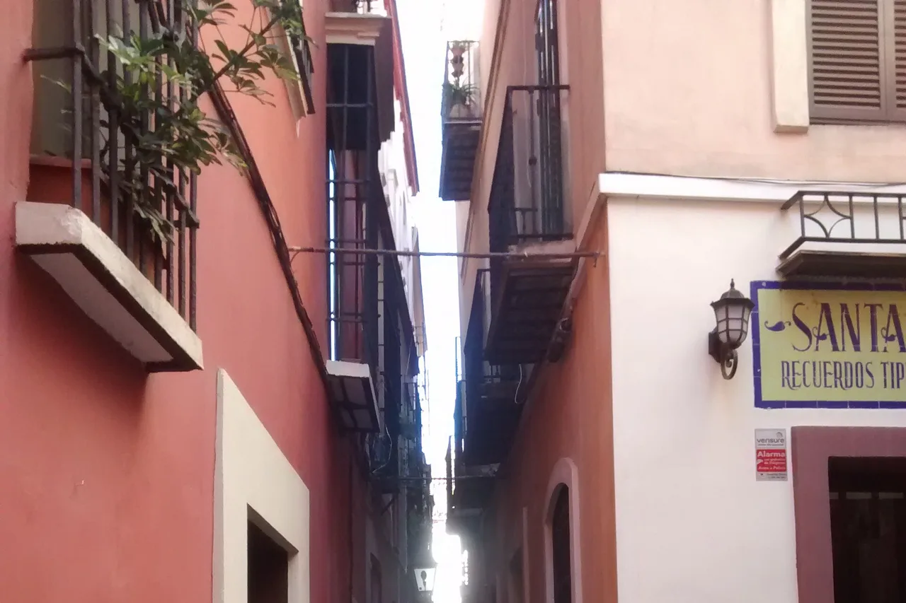 Une ruelle étroite et blanchie à la chaux du quartier de Santa Cruz, à Séville