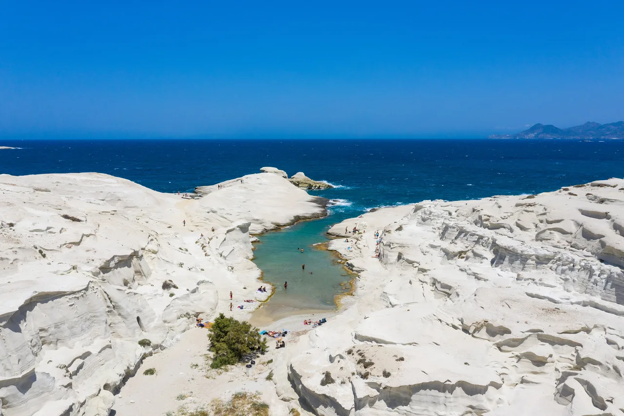 Las rocas blancas de Sarakiniko en Milos y su cala turquesa vistas desde el aire