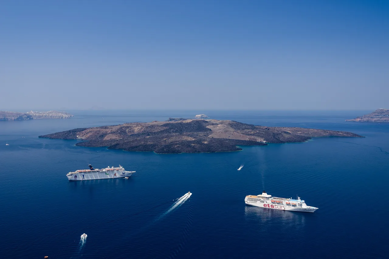 The Santorini caldera seen from Fira, with Nea Kameni and two ships at anchor