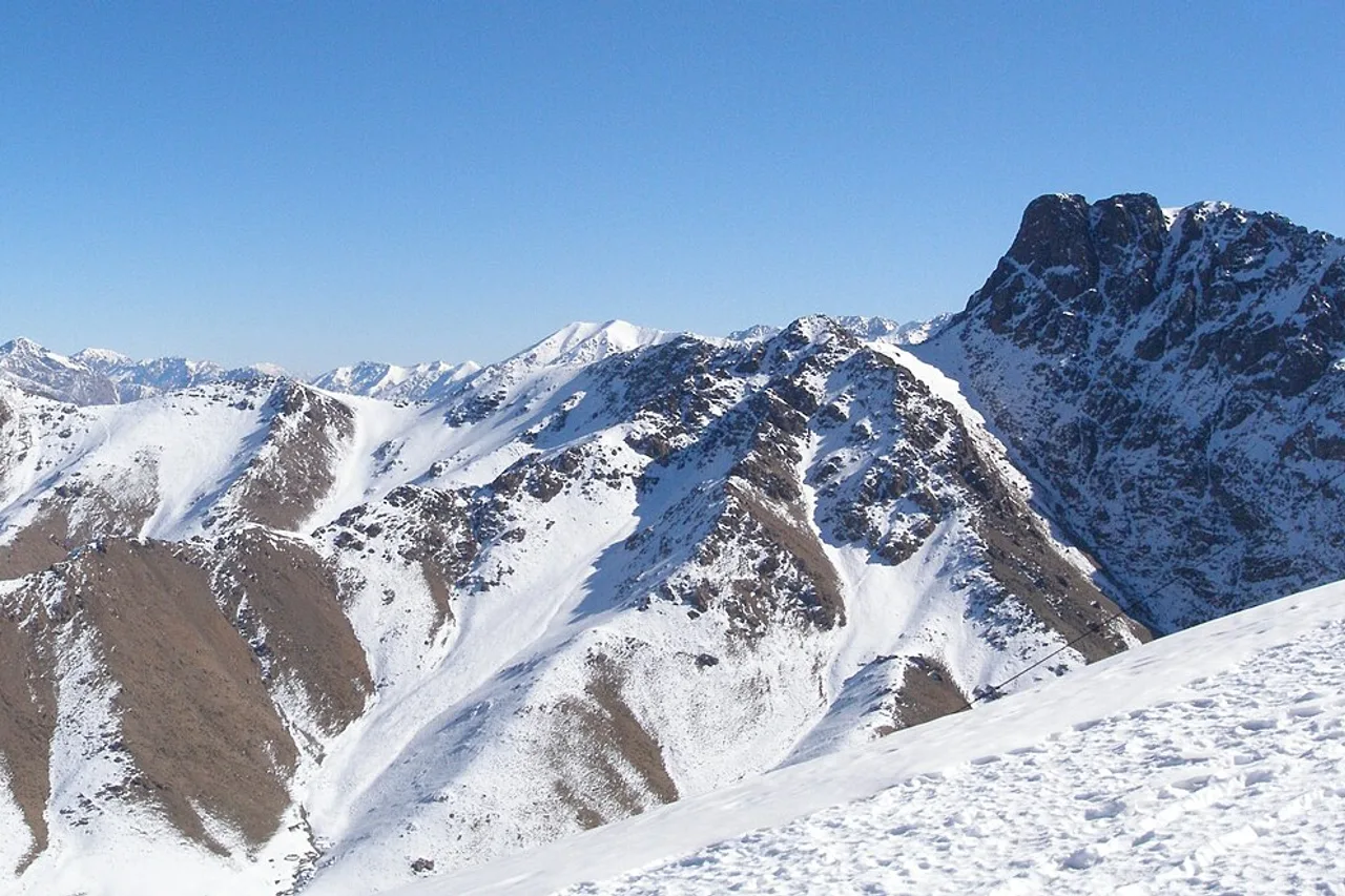 The snow-covered peaks of the High Atlas above Marrakech under a blue winter sky