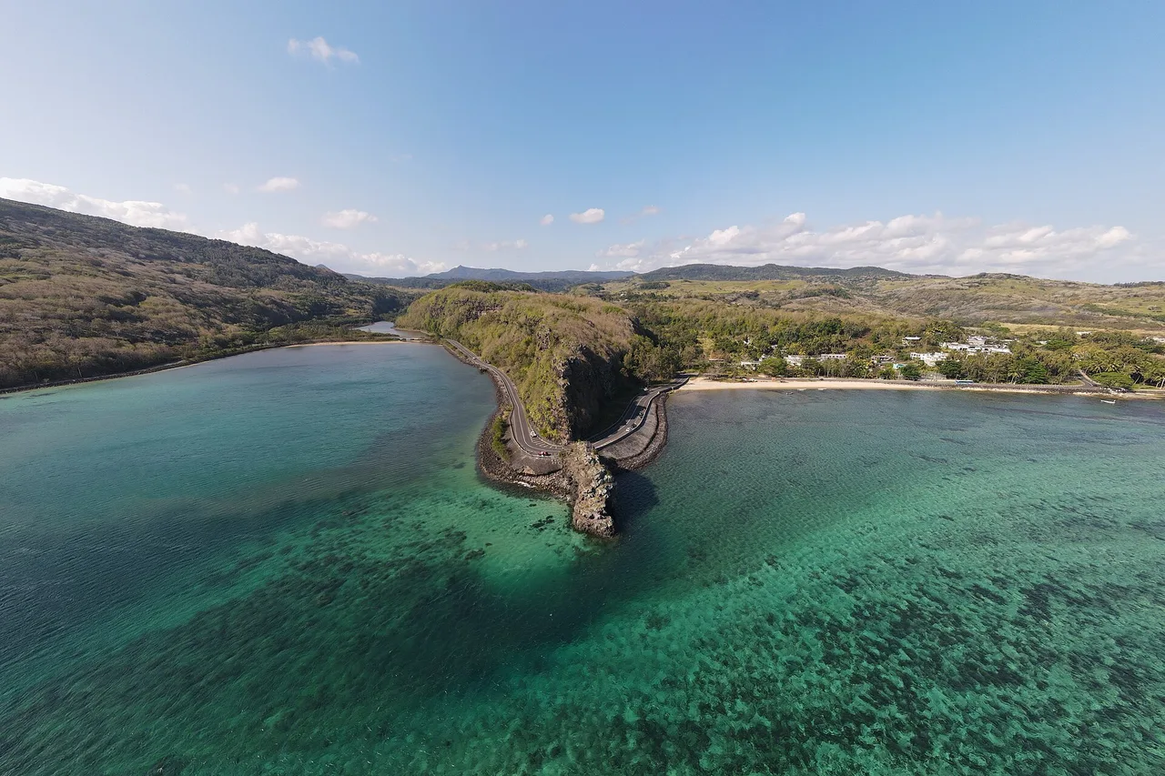 Aerial view of the Macondé rock reaching into the lagoon at Baie du Cap, southern Mauritius