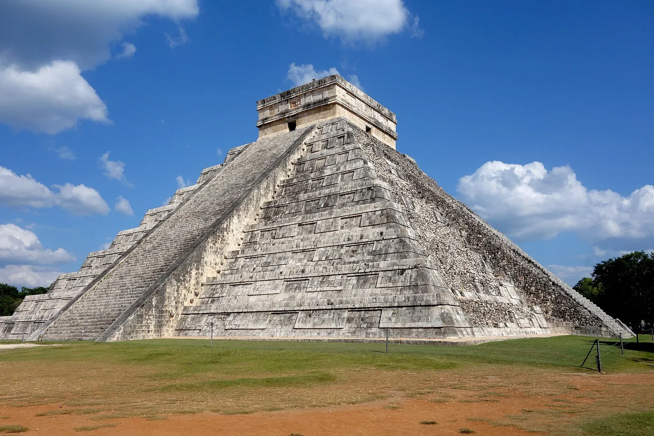 La piramide di Kukulcán a Chichén Itzá, con le sue nove terrazze e la scalinata, sotto un cielo blu intenso