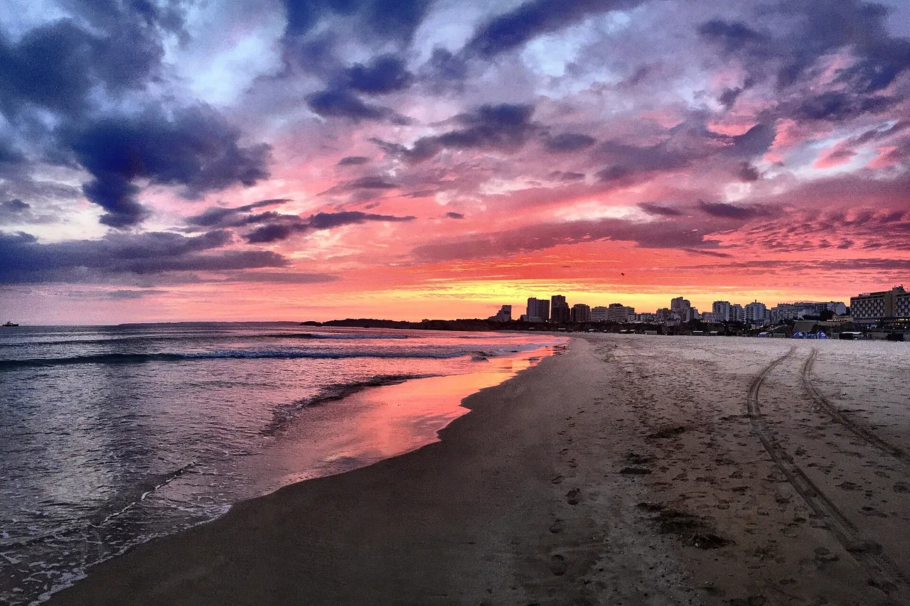 Praia da Rocha in Portimão at sunset, its long urban beach and the apartment blocks lined up above it