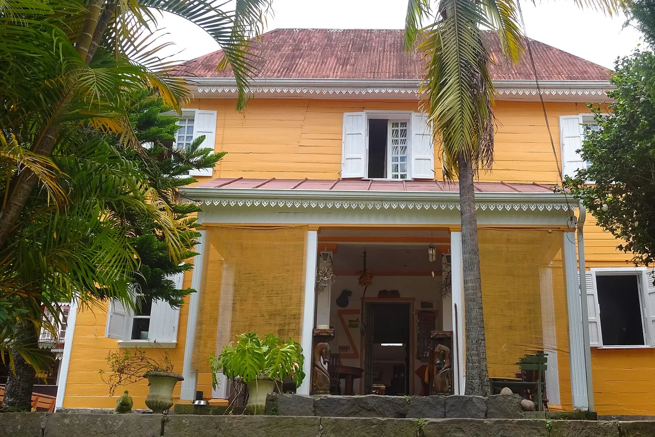 Villa criolla amarilla con veranda y jardín tropical en Hell-Bourg, pueblo clasificado del circo de Salazie