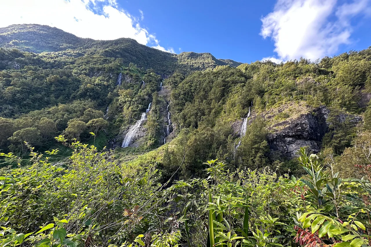 The Voile de la Mariée waterfall in Salazie, several falls down a green rampart, Réunion Island